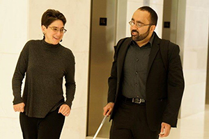 Photo of Amir Rahimi walking with a colleague.