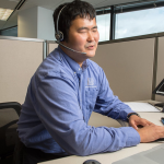 Image of a man using accessible technology in an office workstation.