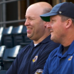 Image of two baseball team employees